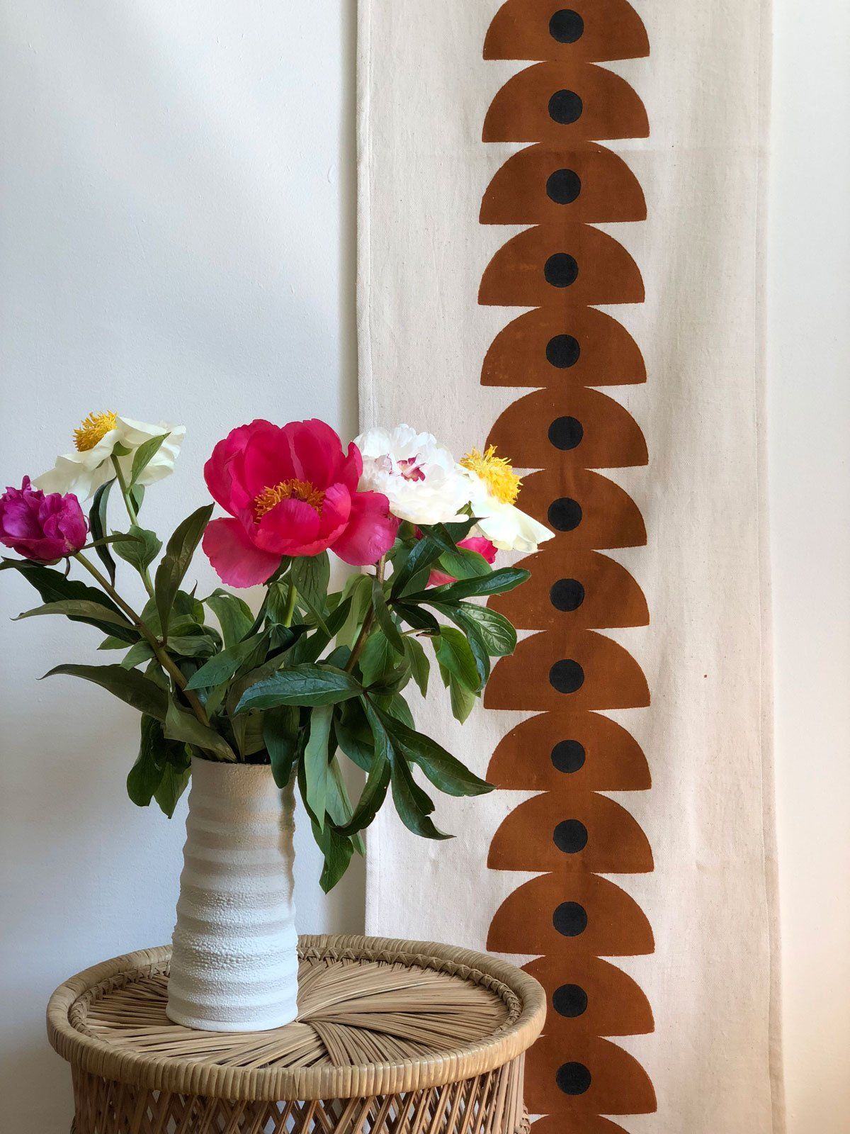 Our handwoven, hand block printed table runner doubles as a stunning wall hanging, sure to liven up any space. Handwoven and hand block printed in Gujarat, India. We work directly with the artisans to ensure our products are ethically made.