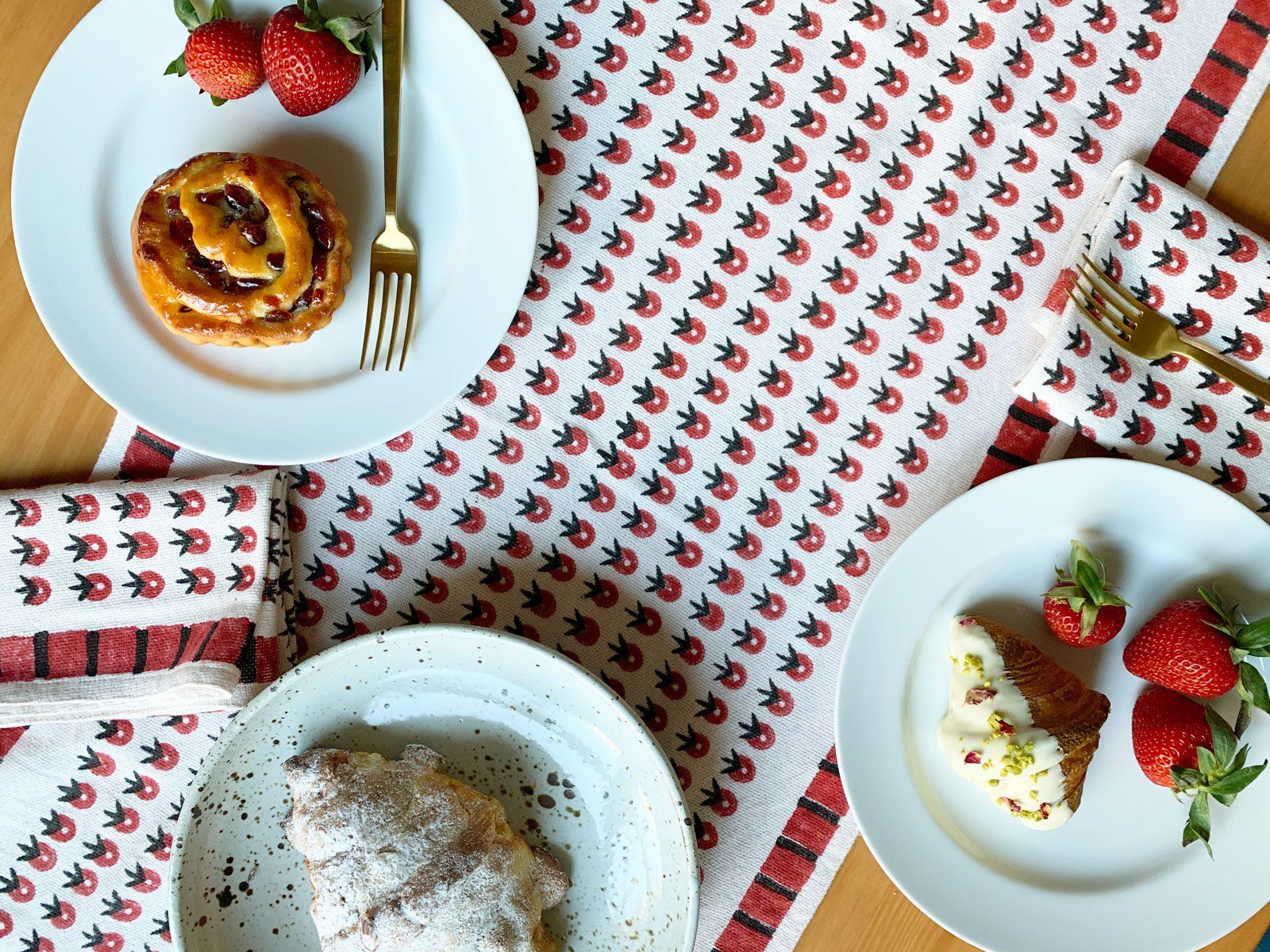 Summery table linens by SUNDAY/MONDAY. A hand block printed table runner and matching cloth napkins featuring a red floral inspired pattern.