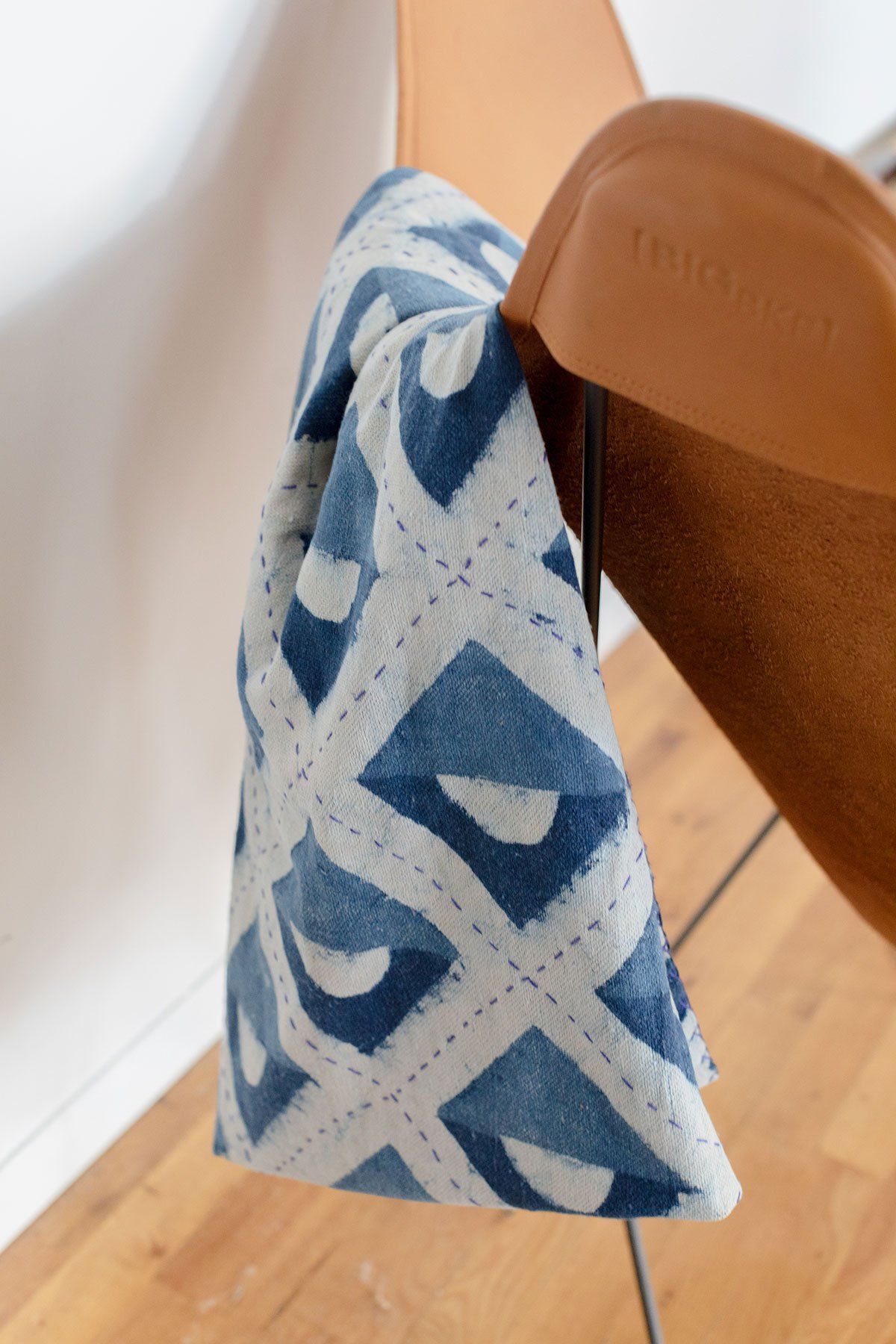 Blue and white hand block printed indigo throw featuring geometric shapes. Lightweight and easy to take with you to the beach or park, or to cuddle up with at home.